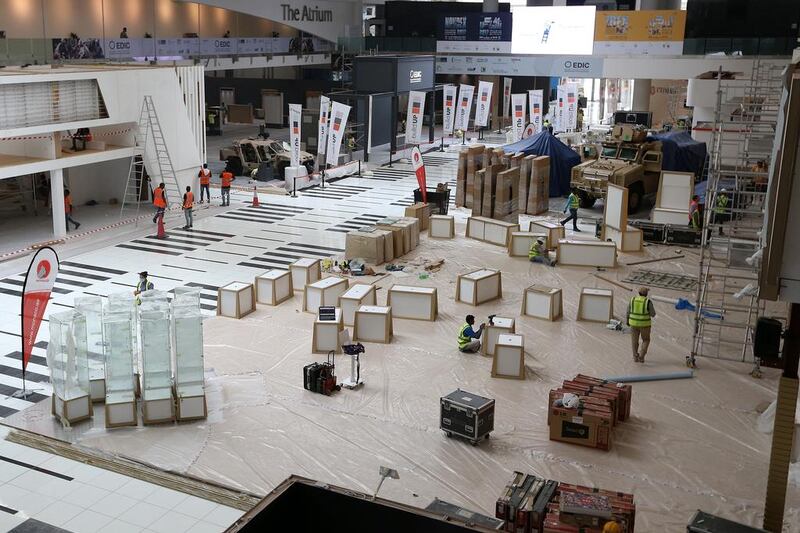 Workers get ready for the International Defence Exhibition and Conference (Idex) taking place in Abu Dhabi next week.