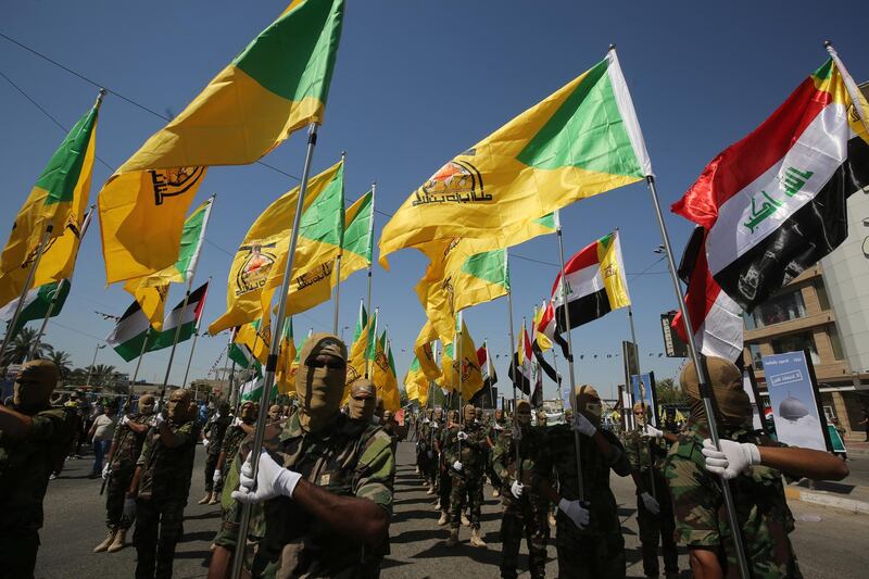 Iraqi Shiite fighters from the Iran-backed armed group, Hezbollah brigades, march during a military parade marking Al-Quds (Jerusalem) International Day in Baghdad, on May 31, 2019. - An initiative started by the late Iranian revolutionary leader Ayatollah Ruhollah Khomeini, Quds Day is held annually on the last Friday of the Muslim fasting month of Ramadan and calls for Jerusalem to be returned to the Palestinians . (Photo by AHMAD AL-RUBAYE / AFP)
