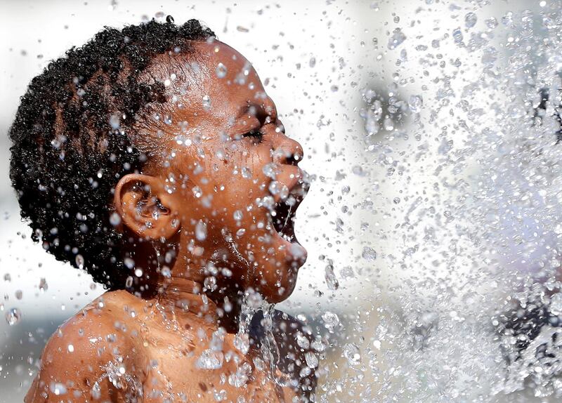 A Belgian boy plays in a fountain on a hot summer day in Brussels. Yves Herman/Reuters