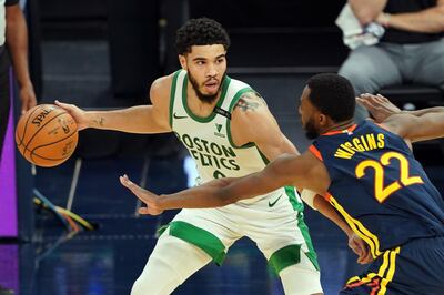 Feb 2, 2021; San Francisco, California, USA; Boston Celtics forward Jayson Tatum (0) handles the ball while being defended by Golden State Warriors forward Andrew Wiggins (22) during the third quarter at Chase Center. Mandatory Credit: Darren Yamashita-USA TODAY Sports