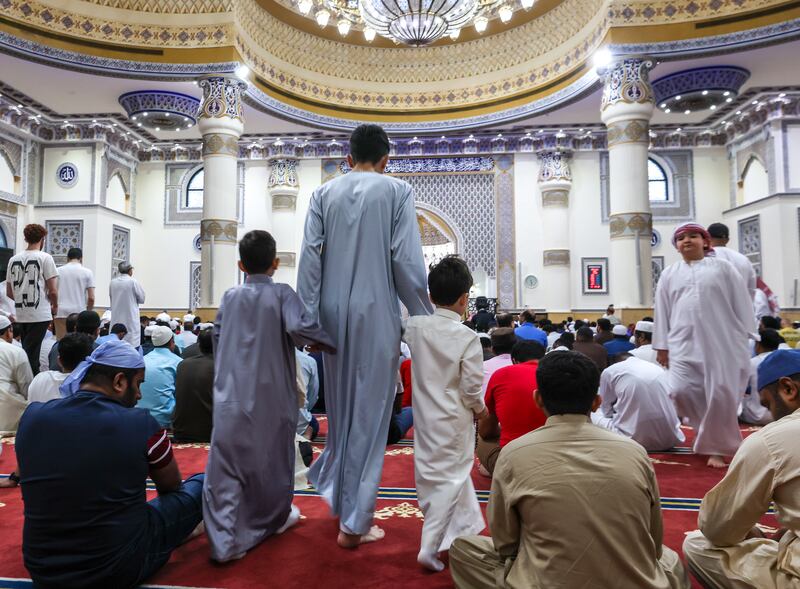 Families attend Eid prayers at the mosque.