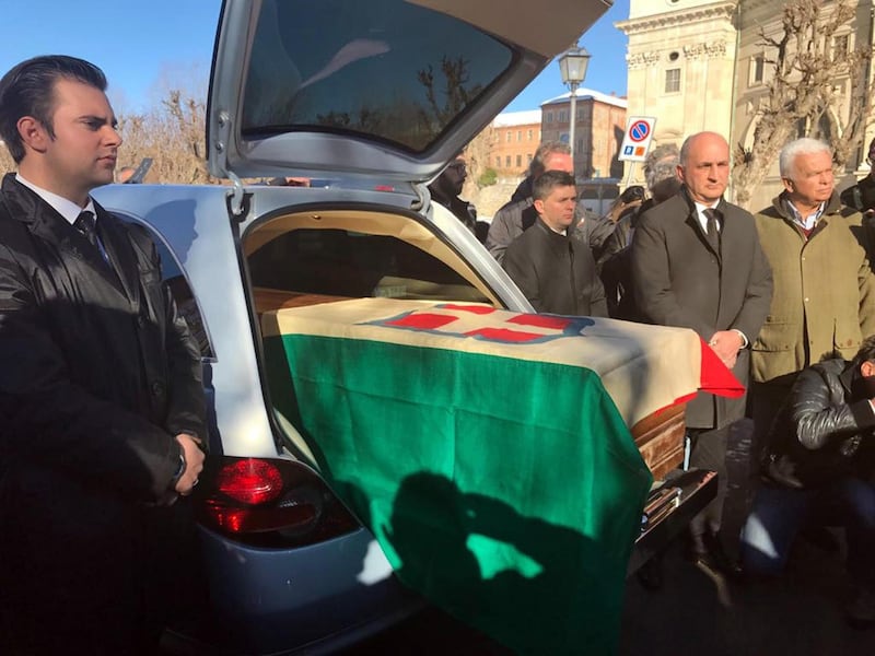 The coffin with the remains of Italy's King Victor Emmanuel III, draped in a flag with the House of Savoy crest, arrives at the Sanctuary of Vicoforte, in Vicoforte, Italy, Sunday, Dec. 17, 2017. The remains were repatriated from Egypt and interred in a family mausoleum Sunday, 71 years after Italians rejected the monarchy in a referendum and the country's royals went into exile. (Raffaele Sasso/ANSA via AP)