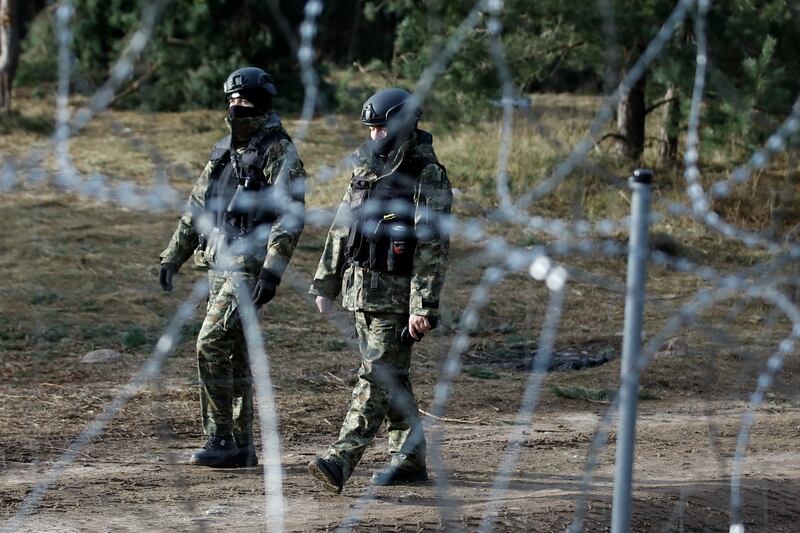 Polish police officers patrol the border. Reuters