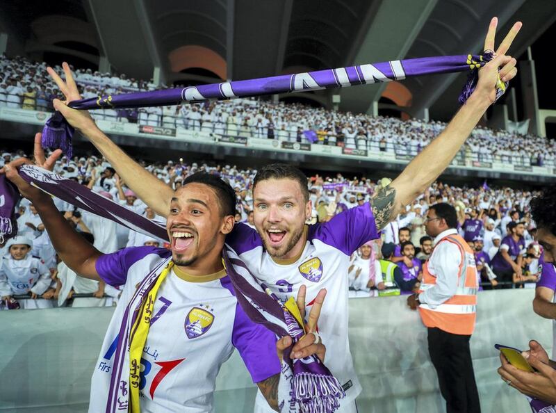 Marcus Berg, right, celebrates with Al Ain teammates after winning the President's Cup following a 2-1 defeat of Al Wasl at Zayed Sports City in Abu Dhabi. Victor Besa / The National