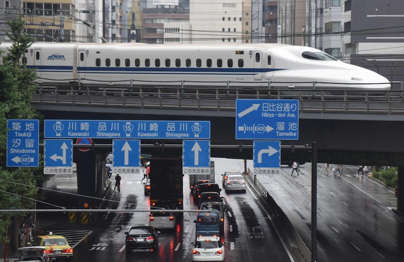 A Shinkansen bullet train moves on tracks above traffic in Tokyo on August 14, 2017.

Japan's economy grew 1.0 percent in the April-June period, notching up its sixth straight quarter of growth and its longest economic expansion in over a decade, government data showed on August 14. / AFP PHOTO / KAZUHIRO NOGI