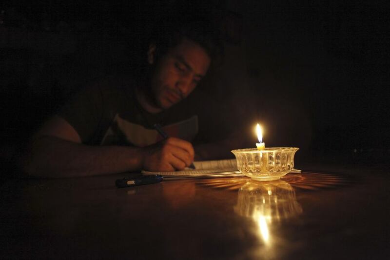 Mostafa Khaled, 20, studies by candlelight for his early morning exams during a power cut in Toukh, El Kalubia governorate, about 25-kilometres northeast of Cairo on May 26, 2013. Amr Abdallah Dalsh / Reuters
