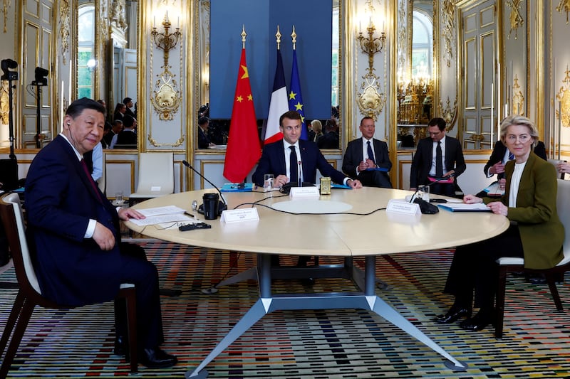 Mr Xi, Mr Macron and Ms von der Leyen at their meeting on Monday. AP