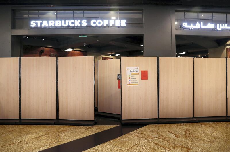 DUBAI, UNITED ARAB EMIRATES , April 29 – 2020 :- Barricades put up around the Starbucks Coffee store during the Ramadan at Mall of the Emirates in Dubai. Authorities ease the restriction for the residents in Dubai. At present mall opening timing is 12:00 pm to 10:00 pm. (Pawan Singh / The National) For News/Standalone/Online. Story by Patrick
