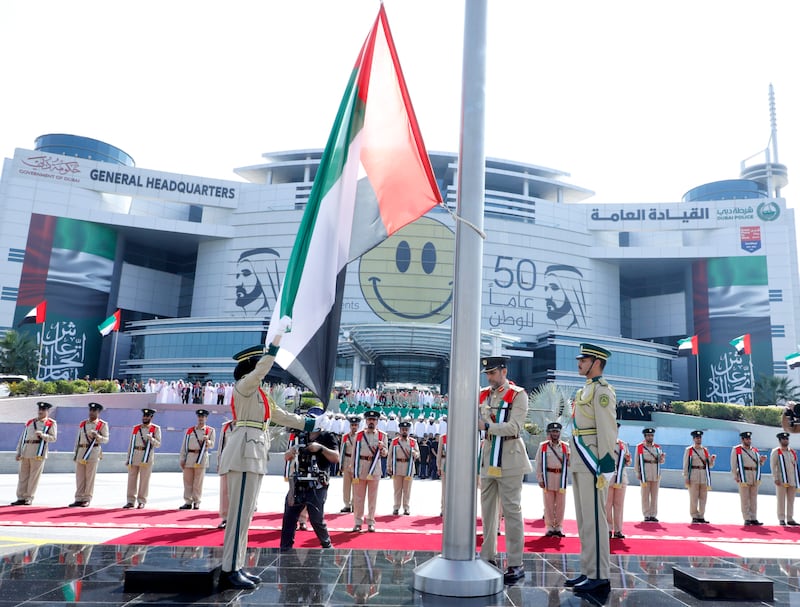 Dubai Police raise the flag at their headquarters in Deira.