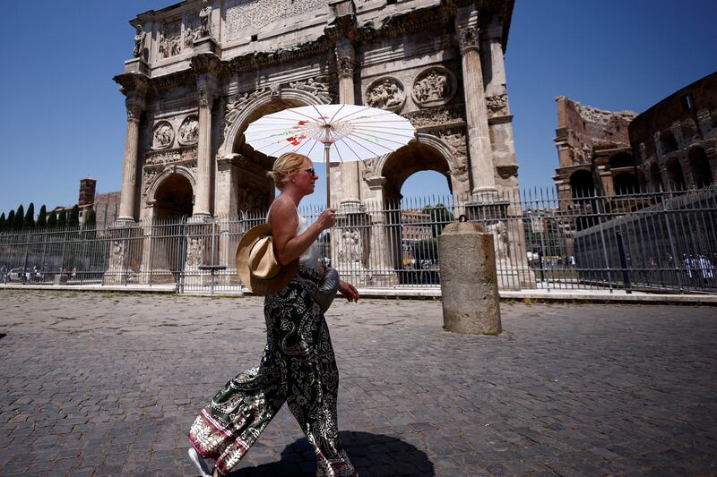 Mathilde from France shelters from the sun near the Colosseum in Rome. Reuters