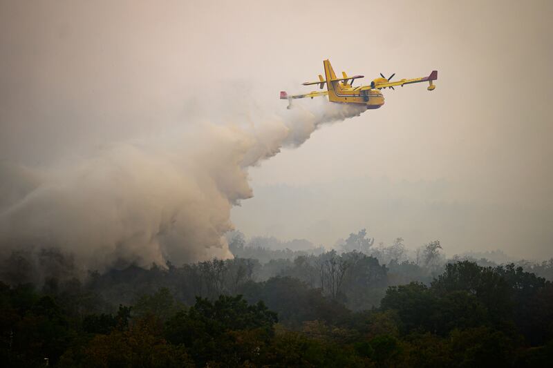 Croatia’s Canadair plane helps to extinguish wildfires close to the village of Kostanjevica na Krasu. AFP