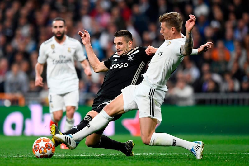 Real Madrid's German midfielder Toni Kroos, right, challenges Ajax's Serbian forward Dusan Tadic. AFP