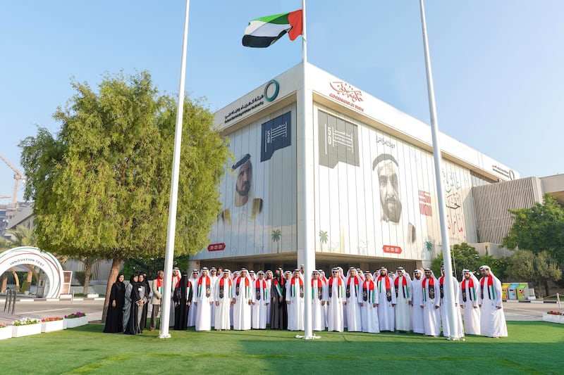 Dubai Electricity and Water Authority  members of staff attend the flag raising ceremony at the headquarters in Umm Hurair.