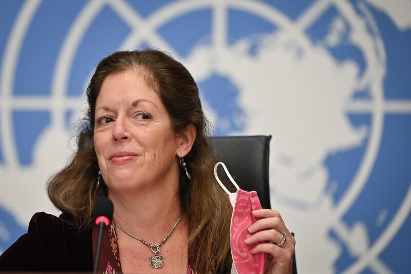 Deputy Special Representative of the UN Secretary-General for Political Affairs in Libya Stephanie Williams removes her protective face mask during a press conference on talks between the rival factions in the Libya conflict on October 21, 2020 at the United Nations offices in Geneva. The UN's Libya envoy said she was "quite optimistic" about the prospects of a ceasefire emerging from ongoing talks between the two warring factions. Two days into the talks at the United Nations in Geneva, scheduled to last until October 24, 2020, the two sides agreed to open internal land and air routes. / AFP / POOL / Fabrice COFFRINI
