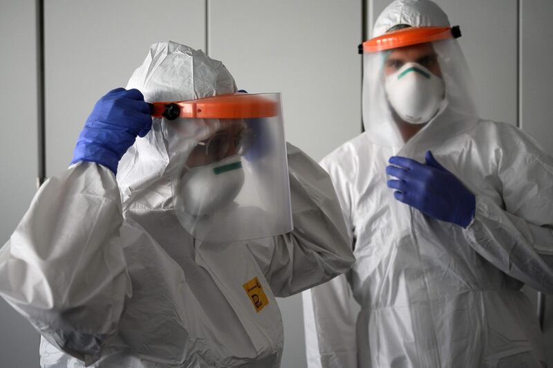 Nurses put on their Personal Protective Equipment (PPE) before starting to work on the preparation of the Intensive care unit in the new Covid-19 Hospital in Verduno, near Alba, Northwestern Italy on the eve of its official opening. AFP