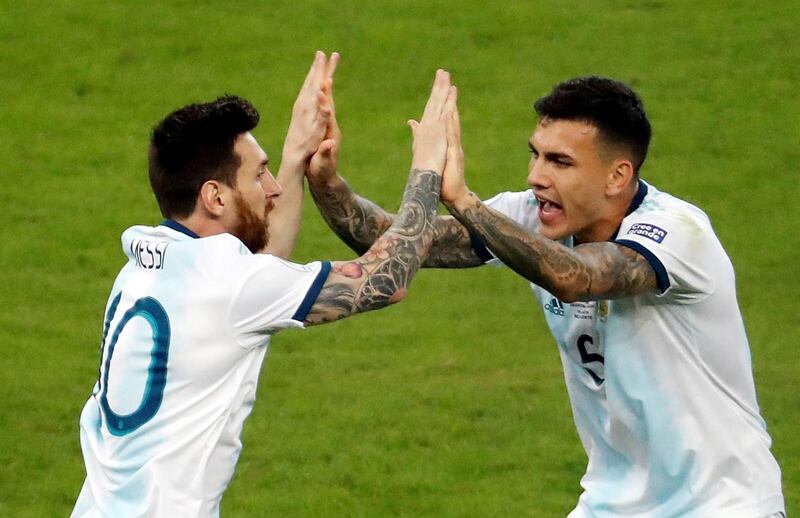 Argentina's Lionel Messi, left, reacts after scoring against Paraguay. EPA