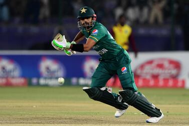 Pakistan's captain Babar Azam watches the ball after playing a shot during the third Twenty20 international cricket match between Pakistan and West Indies at the National Stadium in Karachi on December 16, 2021.  (Photo by ASIF HASSAN  /  AFP)