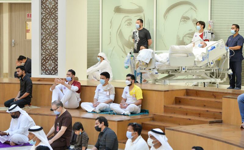 Long-term patients and their family take part in the special Eid  prayers in the atrium. 