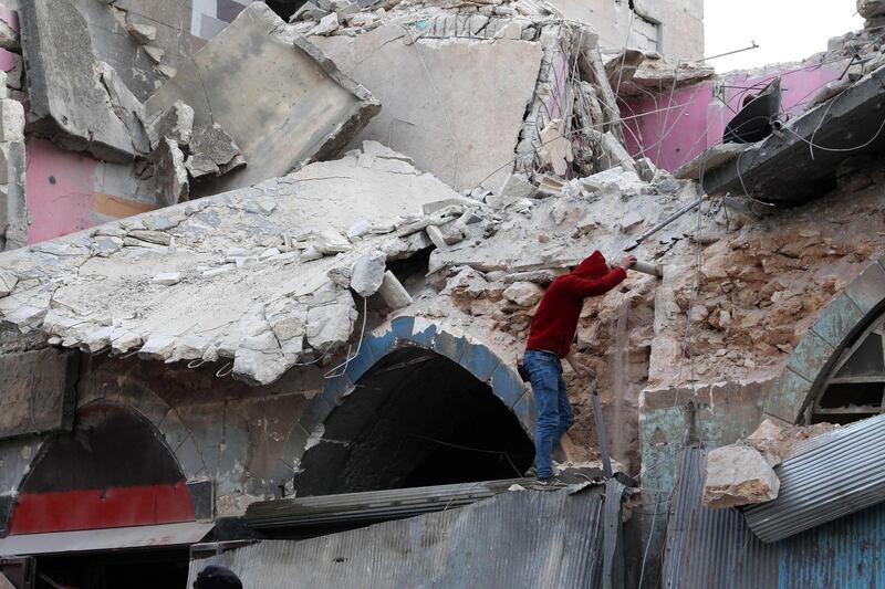 A youth stands at the site of a regime air strike in Ariha town in Syria's last major opposition bastion of Idlib. AFP