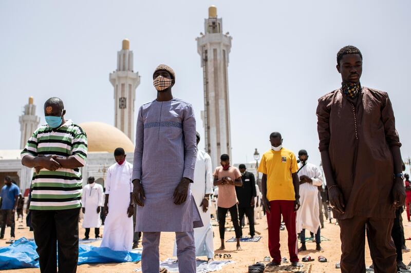 Followers of the Senegalese Mouride brotherhood, an order of Sufi Islam, attend Muslim Friday prayers at West Africa's largest mosque the Massalikul Jinaan, in Dakar, Senegal.  AP Photo