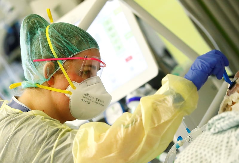 A nurse shaves a patient suffering from Covid-19 at the Intensive Care Unit of the "Klinikum Darmstadt" clinic in Darmstadt, Germany. Reuters