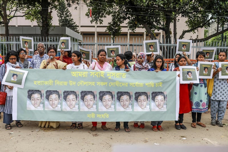 In this photo taken on April 12, 2019 Bangladeshi women hold banners and photographs of schoolgirl Nusrat Jahan Rafi at a protest in Dhaka, following her murder by being set on fire after she had reported a sexual assault. A schoolgirl was burned to death in Bangladesh on the orders of her head teacher after she reported him for sexually harassing her, police said April 19. The death of 19-year-old Nusrat Jahan Rafi last week sparked protests across the South Asian nation, with the prime minister promising to prosecute all those involved.

 / AFP / SAZZAD HOSSAIN
