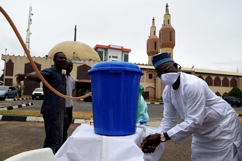 A man wash hands with sanitiser as he arrives at a mosque in Lagos on August 7. Pius Utomi Ekpei / AFP