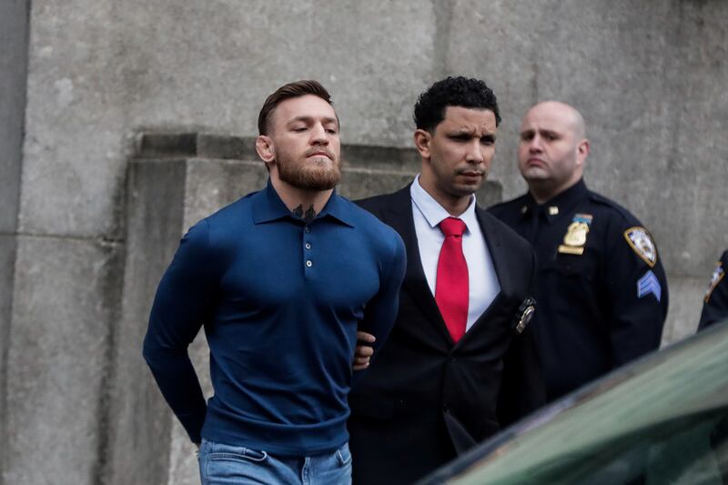 Conor McGregor walks out of the 78th police precinct after charges were laid against him following a late night melee in the Brooklyn borough of New York City on April 6, 2018.