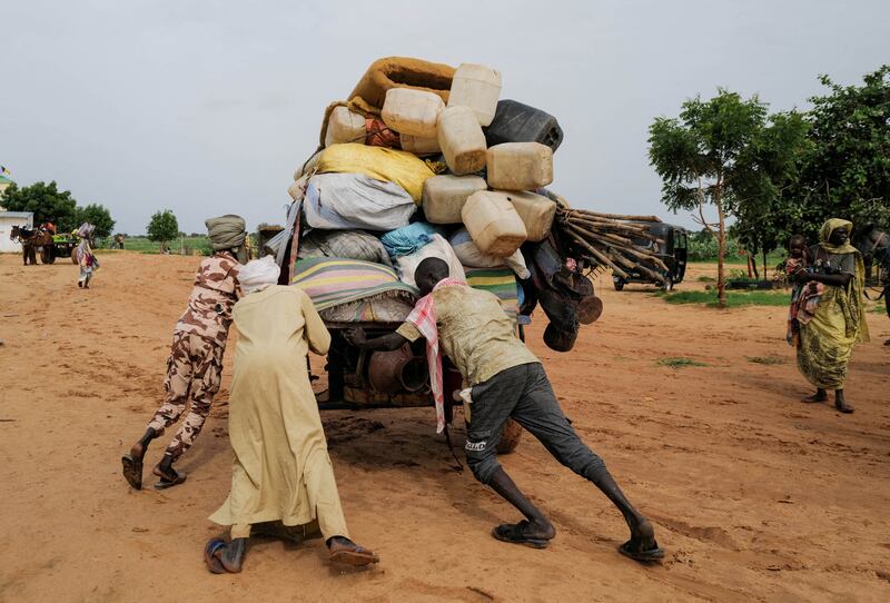 A Chadian cart owner transports the belongings of Sudanese people who fled the conflict in Darfur across the border with Sudan in Adre, Chad. Reuters