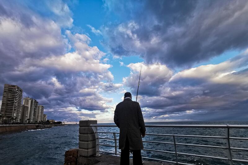 A man casts his fishing line into the Mediterranean Sea from the promenade in Beirut during cold weather. AP Photo