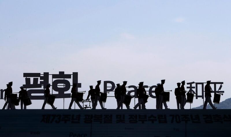 South Korean honour guards walk near a sign that reads "Peace" before a ceremony to celebrate the Korean Liberation Day in Seoul. Lee Jin-man / AP Photo