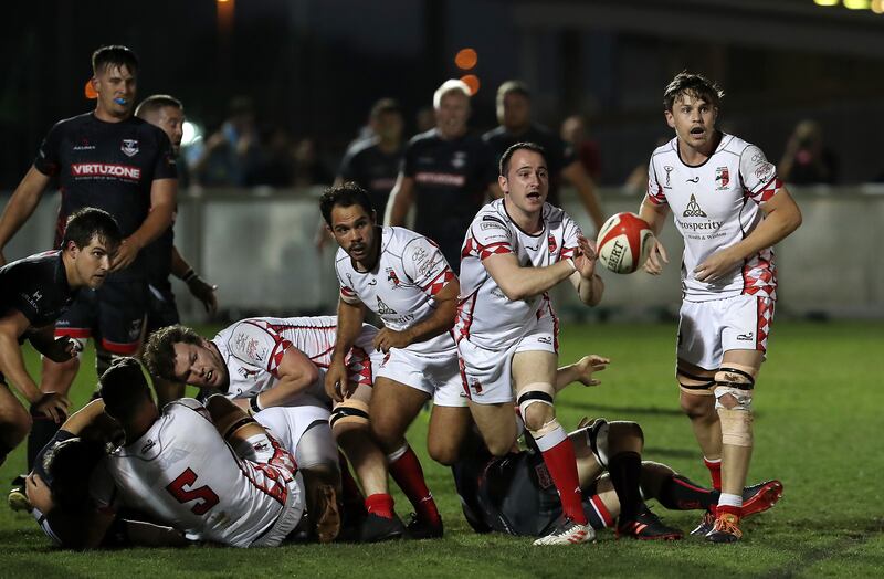 Abu Dhabi Harlequins pass the ball against Dubai Exiles.