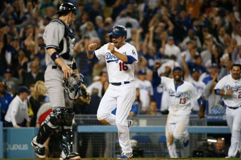 The Dodgers' Andre Ethier, second from left, celebrates as he runs towards home plate to score on an RBI single hit by Mark Ellis at the bottom of the ninth inning. Lucy Nicholson / Reuters