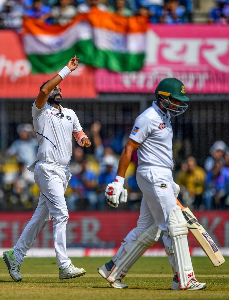 India bowler Mohammed Shami, left, celebrates after taking the wicket of Bangladesh's Mahmudullah. AFP