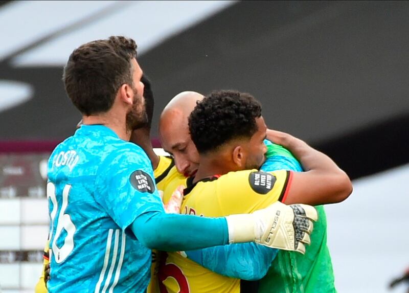 Watford players in a group hug after the club's relegation from the Premier League. EPA
