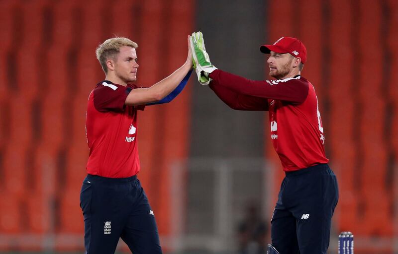 England bowler Sam Curran, left, celebrates with Jos Buttler after the dismissal of India's Suryakumar Yadav. AP