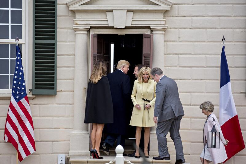 US President Donald Trump, centre, walks into the Mansion at the Mount Vernon estate of first US President George Washington with US First Lady Melania Trump, left, Emmanuel Macron, France's president, centre right, and Brigitte Macron, France's first lady, yellow, in Mount Vernon, Virginia, US, on Monday, April 23, 2018. Andrew Harrer / Bloomberg