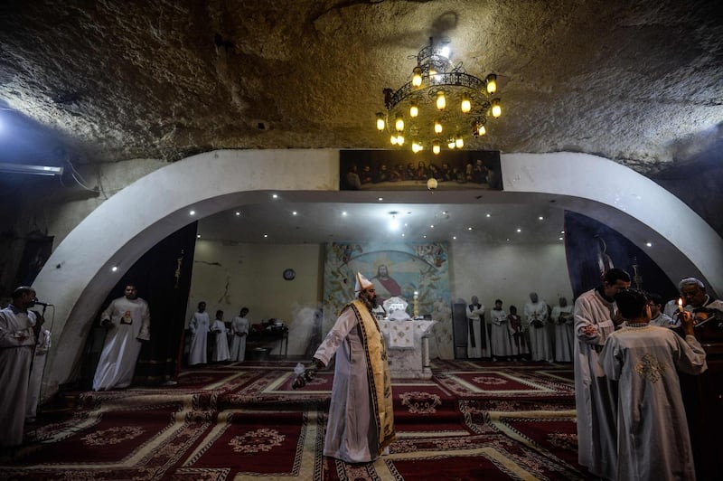 A priest leads the Epiphany Mass at the Monastery of St Simon in Cairo. AFP