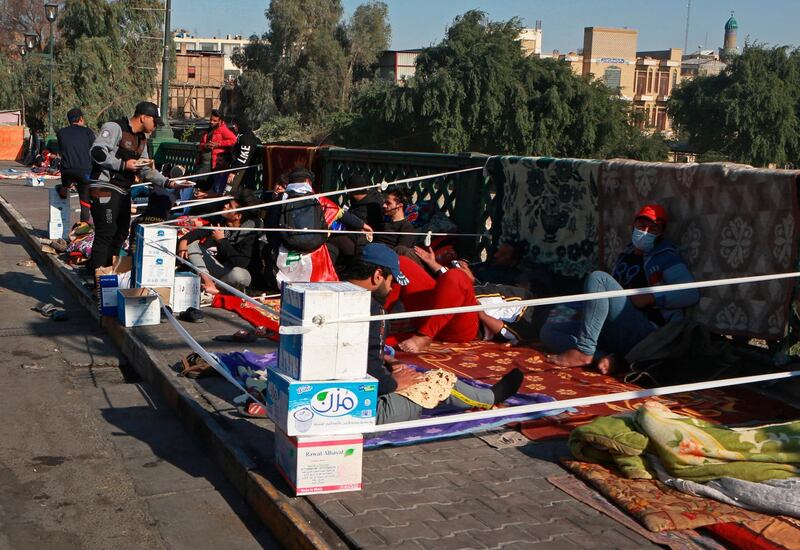 Protesters stage a sit-in on the Ahrar Bridge in Baghdad. AP Photo