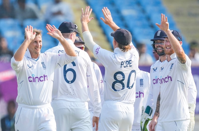 England's Joe Root, left, celebrates after taking the wicket of India's Ravindra Jadeja. AP