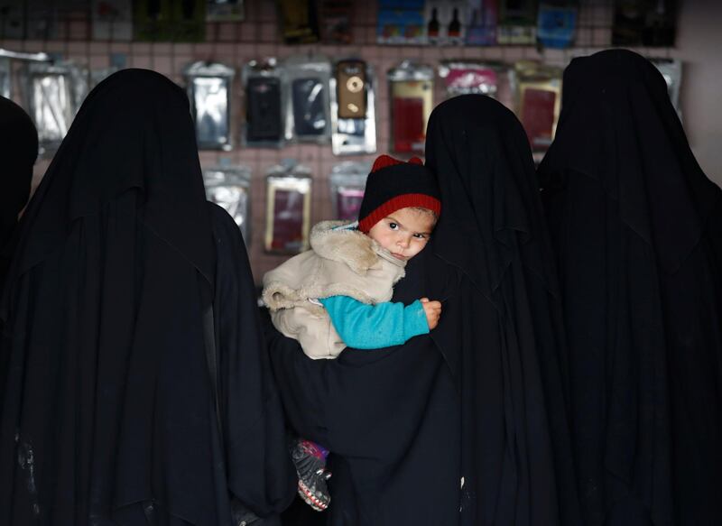 A child is held by a woman inside a shop in al-Hol camp, Syria, January 8, 2020. REUTERS/Goran Tomasevic     SEARCH "ISLAMIC STATE PRISONERS" FOR THIS STORY. SEARCH "WIDER IMAGE" FOR ALL STORIES.