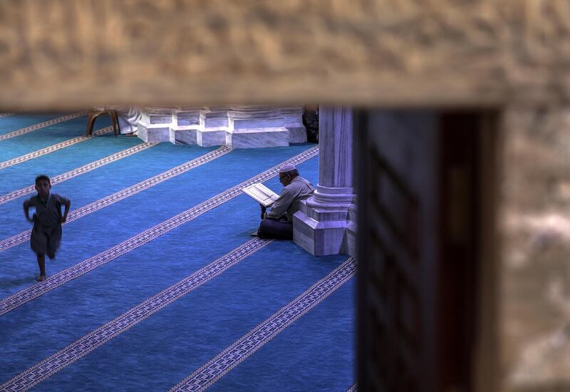 A Palestinian reads from the Quran at Al Omari mosque in Gaza City.  EPA