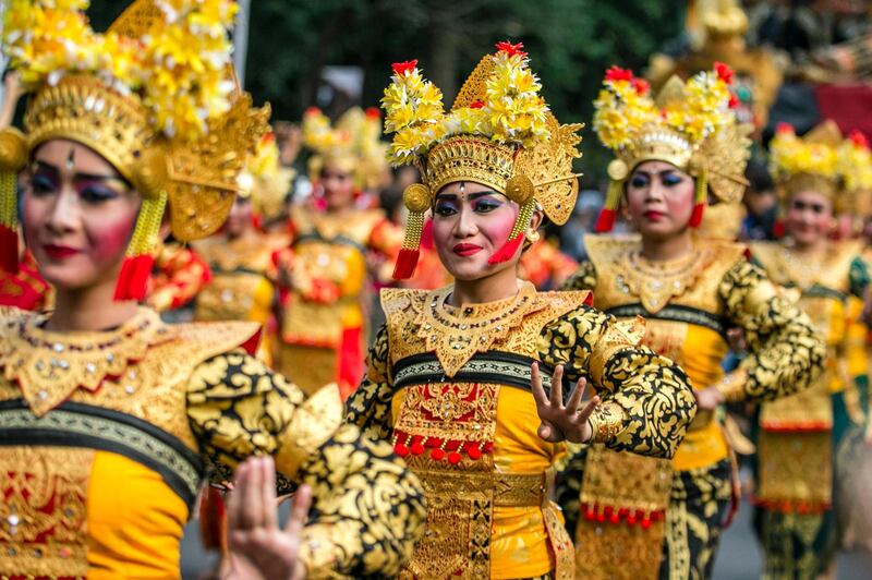 Balinese dancers take part in a parade to mark the opening of the annual Bali Art Festival on a main road in Denpasar, Bali, Indonesia.  Made Nagi / EPA