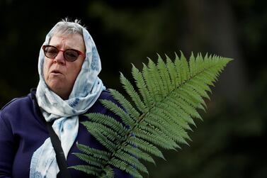 A woman holds a fern during a vigil for the victims of the mosque attacks during an ecumenical celebration in Christchurch, New Zealand, on March 21, 2019. Reuters