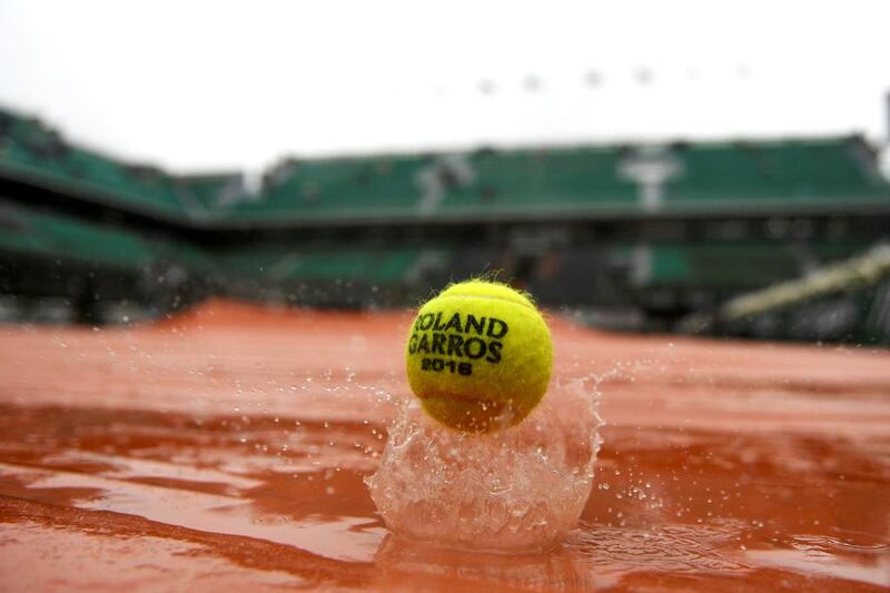 A ball on the tarp covering the Philippe Chatrier central court as rain falls over Roland Garros. Martin Bureau / AFP