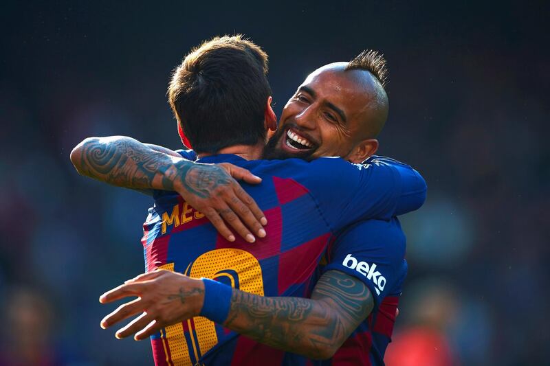 Barcelona striker Lionel Messi (L) celebrates with teammate Arturo Vidal. EPA