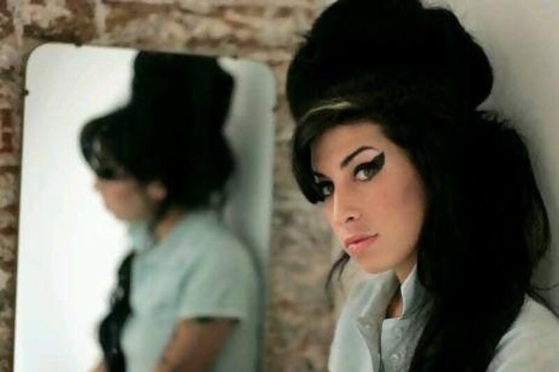 FILE - In this Feb. 16, 2007 file photo, British singer Amy Winehouse poses for photographs after being interviewed by The Associated Press at a studio in north London. Amy Winehouse, the beehived soul-jazz diva whose self-destructive habits overshadowed a distinctive musical talent, was found dead Saturday in her London home, police said. She was 27. (AP Photo/Matt Dunham, File) *** Local Caption *** Britain Obit Amy Winehouse.JPEG-04a24.jpg