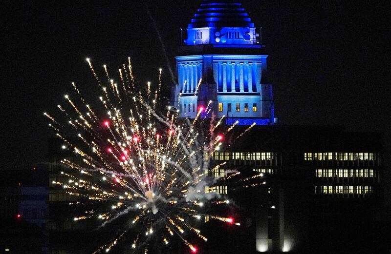 Los Angeles City Hall is illuminated with dark blue lights as Dodgers fans celebrate with fireworks on Sunset Boulevard after Los Angeles Dodgers defeated the Tampa Bay Rays 3-1 and won the World Series. AP