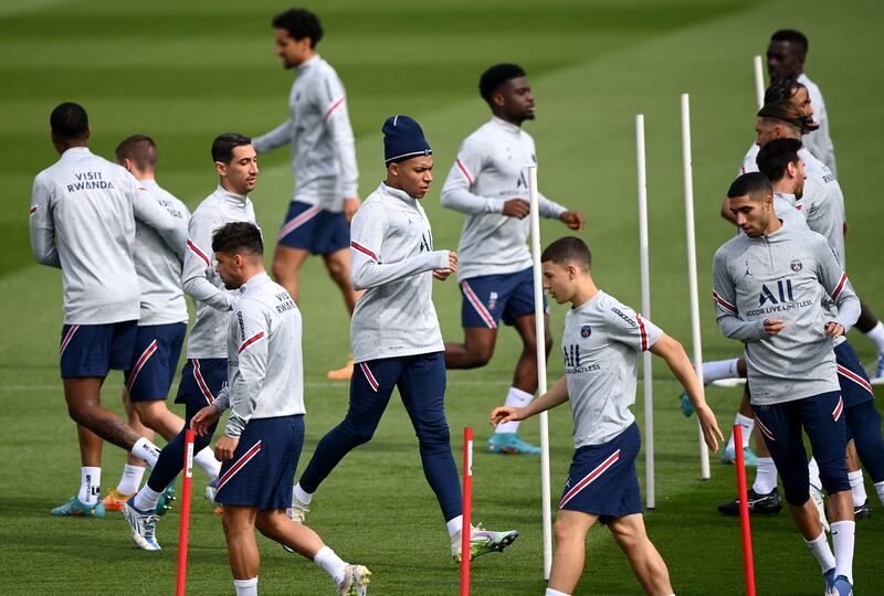 PSG's forward Kylian Mbappe, centre, training with teammates. AFP