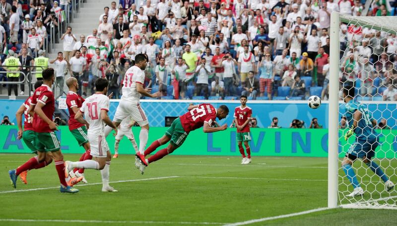 Match 3: Morocco's Aziz Bouhaddouz scores an own goal against Iran. Reuters